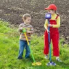 2 kids are detecting treasure on the ground.