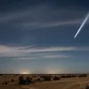 A meteor glides across the sky.
