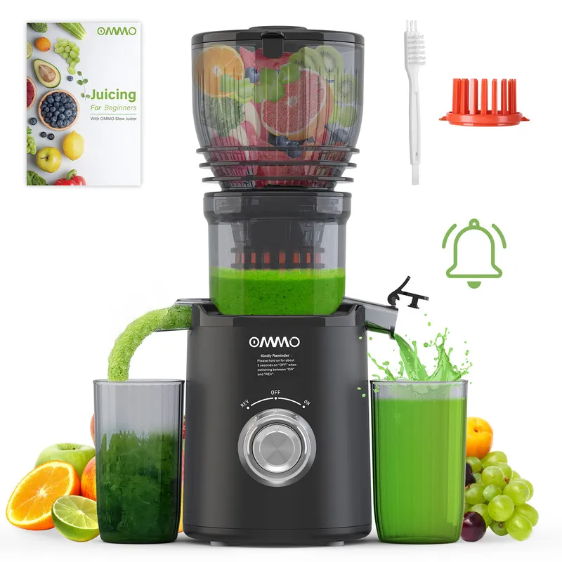 The juicer squeezes juice while discharging waste A black juicer is making healthy green juice.