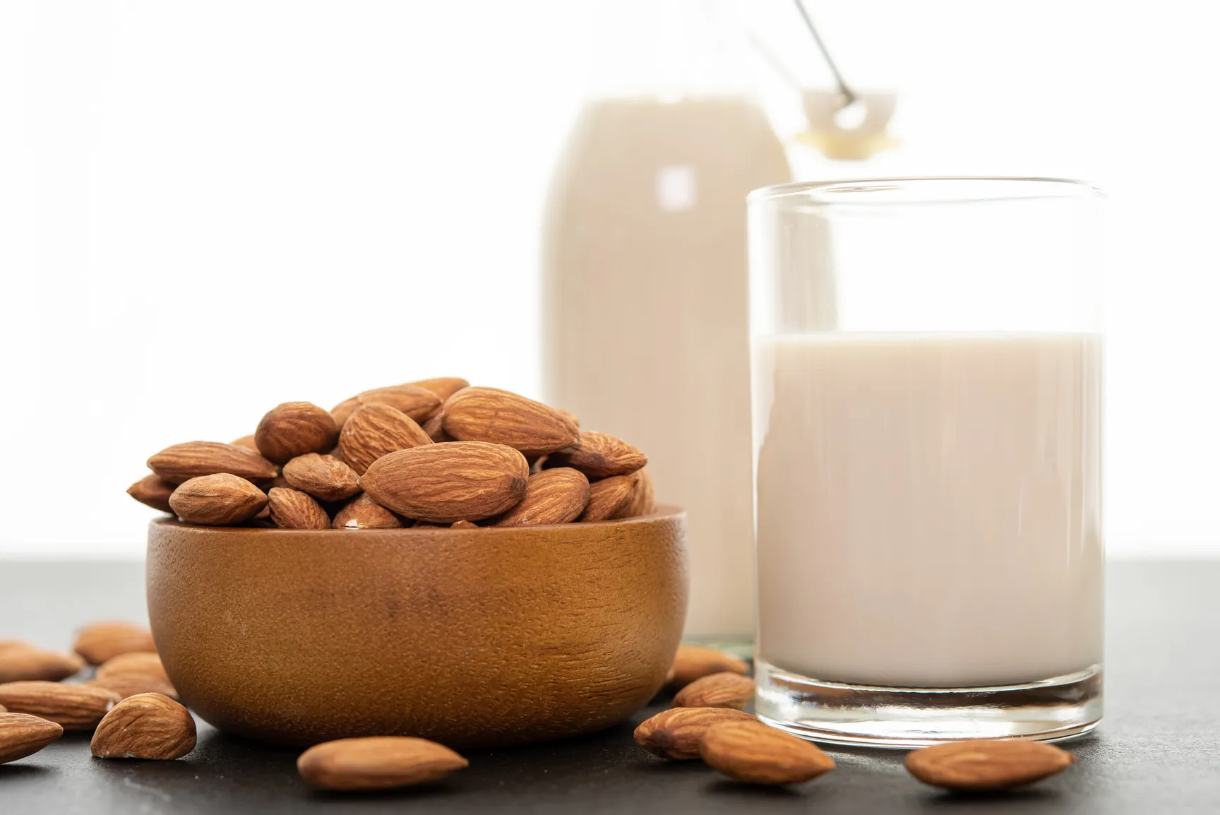 Two cups of milk and a pan of nut are on the table.